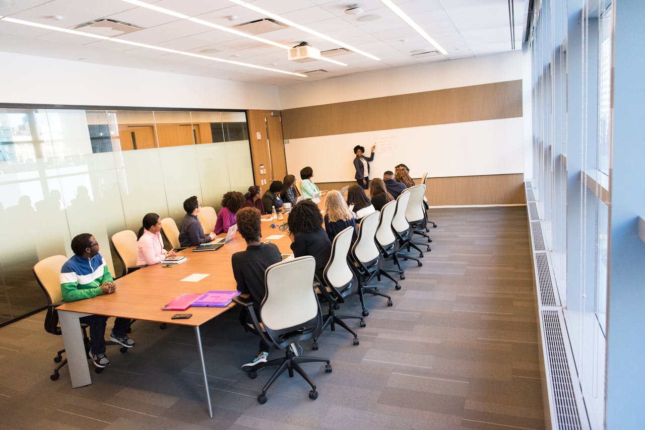 Services-03 A diverse group actively collaborating in a bright, modern conference room setting.